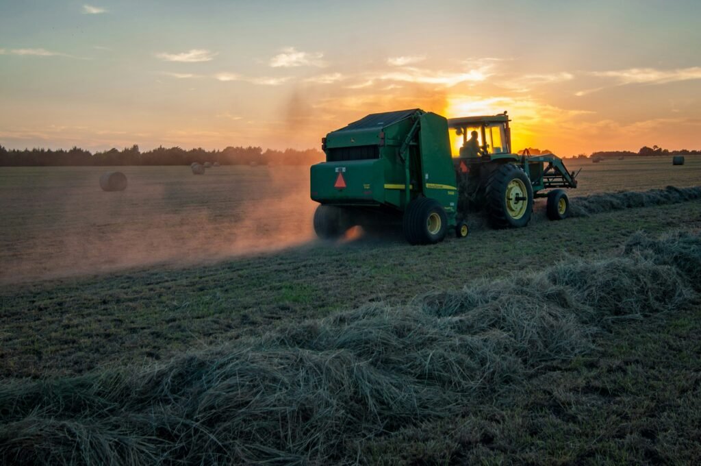 green farm heavy equipment on green field